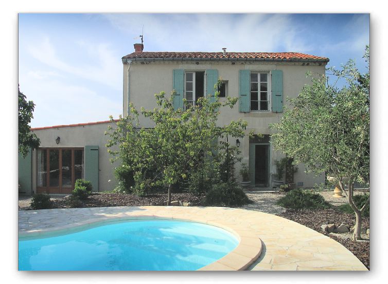 Wider view of the south face of the house from the garden and pool. 
